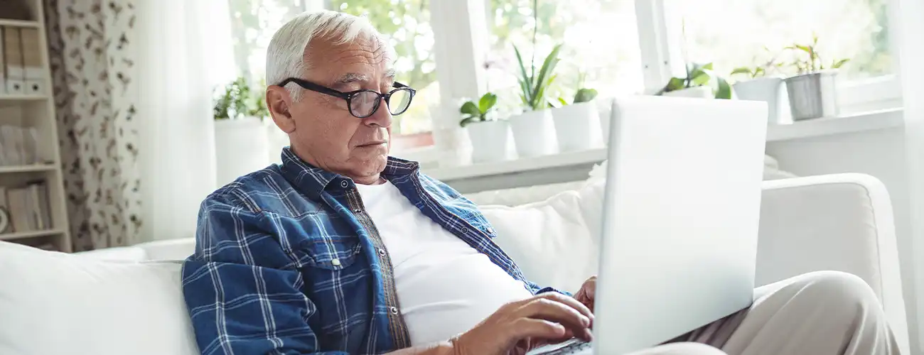 older man looking at computer