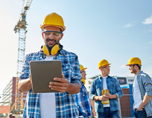 Construction business owner paying bills from tablet
